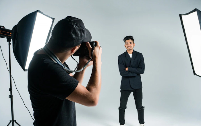 person is pausing for taking passport size photo in a studio